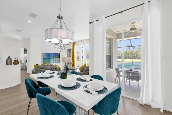 Elegant dining area with direct access to the screened lanai, creating a seamless indoor-outdoor dining experience