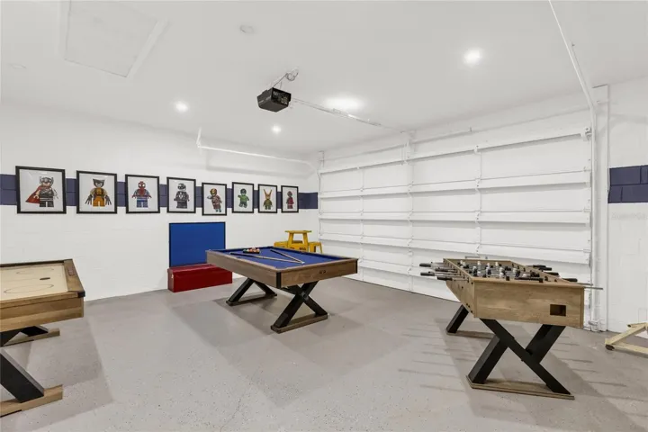 Spacious game room featuring pool table, foosball, and multiple entertainment options