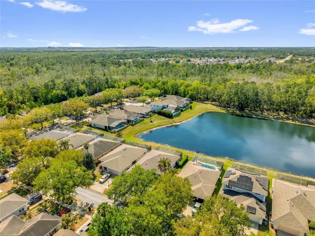 Panoramic aerial view capturing the expansive lake, surrounding homes, and scenic neighborhood setting