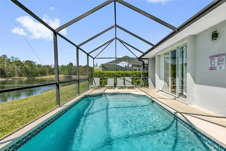 Private screened-in pool with serene lake views, offering a perfect outdoor retreat for relaxation and entertaining