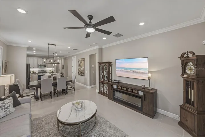 Great Room with upgraded lighting package, crown molding and all tile flooring