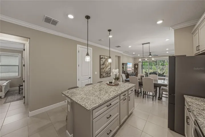 Large Center Kitchen Island with Trash and Recycle Built ins, Roll outs and Bar top seating