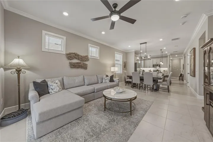 Spacious Great Room with Open Dining Area and Crown Molding Throughout