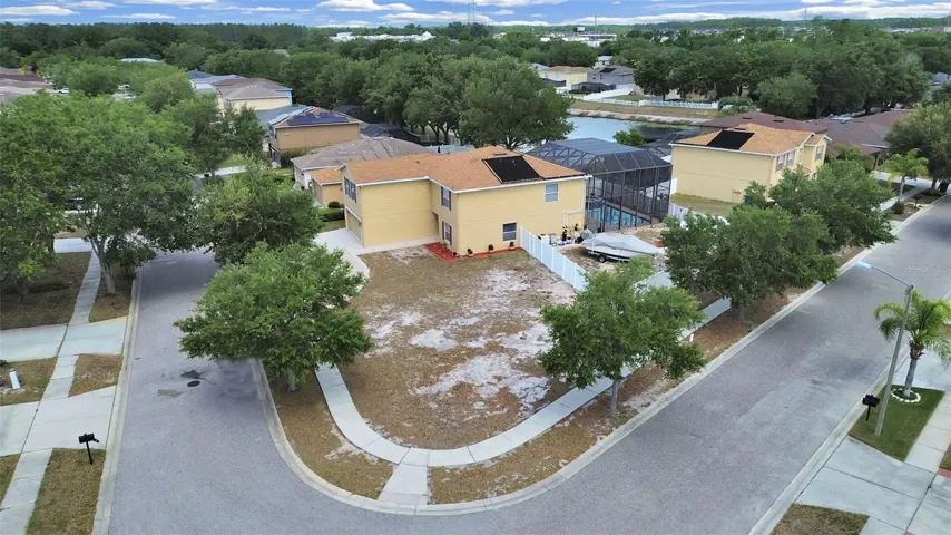The corner lot advantage on FULL display! The impressive footprint, screened pool enclosure, and mature trees that make this property stand out.