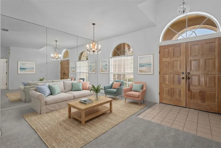 Entry opens directly into the great room with views of the pool and conservation - virtually staged