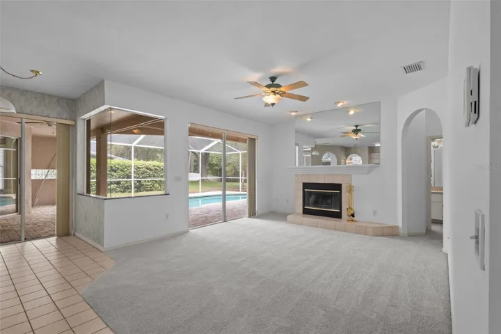Living area with wood-burning fireplace and access to outdoor space.