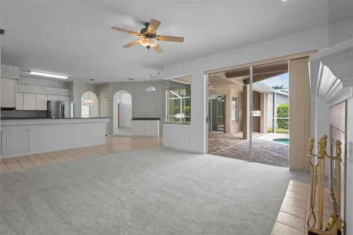 Living area with wood-burning fireplace and access to outdoor space.