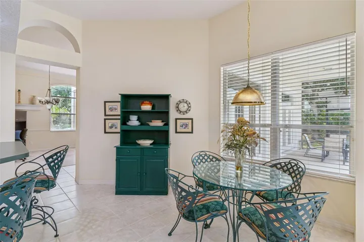 Kitchen overlooking the family room, breakfast noon, and pool