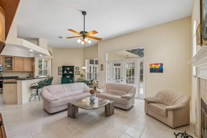 Family room with wood burning fireplace overlooking the pool