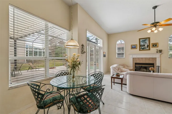 Kitchen overlooking the family room, breakfast noon, and pool