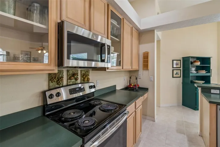 Kitchen overlooking the family room, breakfast noon, and pool