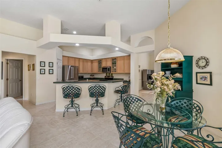 Kitchen overlooking the family room, breakfast noon, and pool