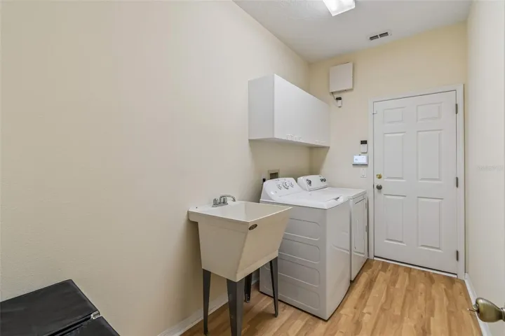 inside laundry room with utility sink
