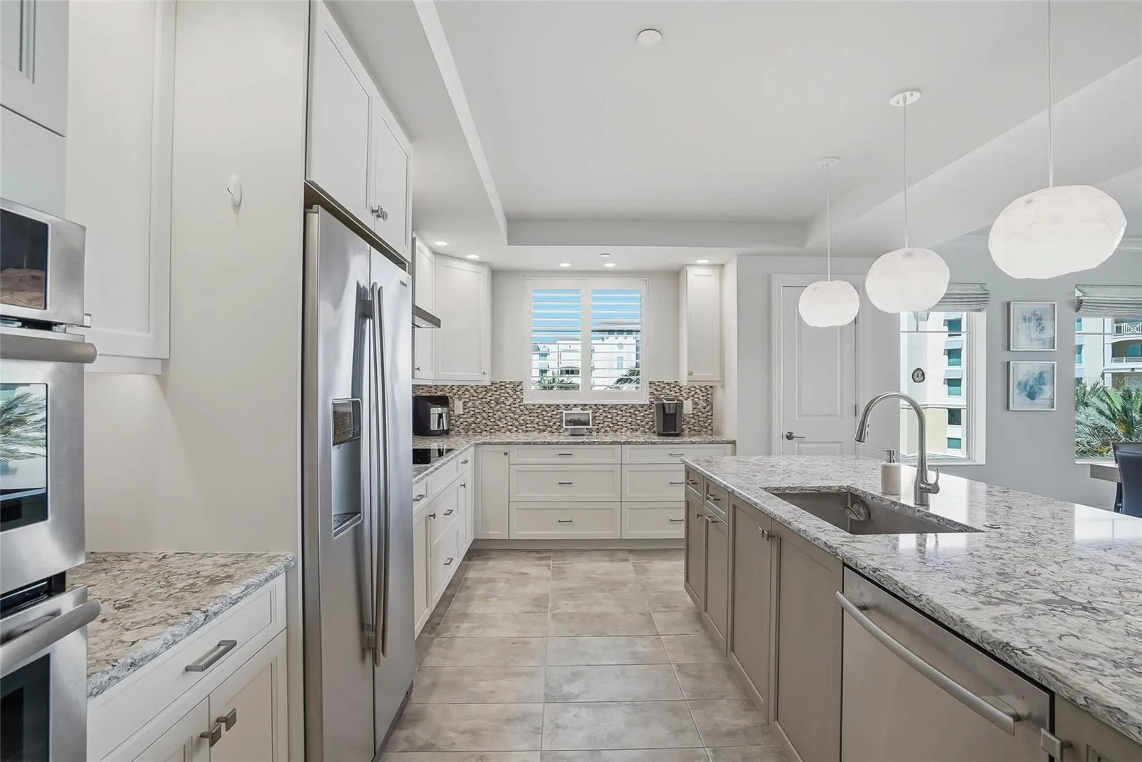 Bright kitchen with stone countertops and generous cabinetry.