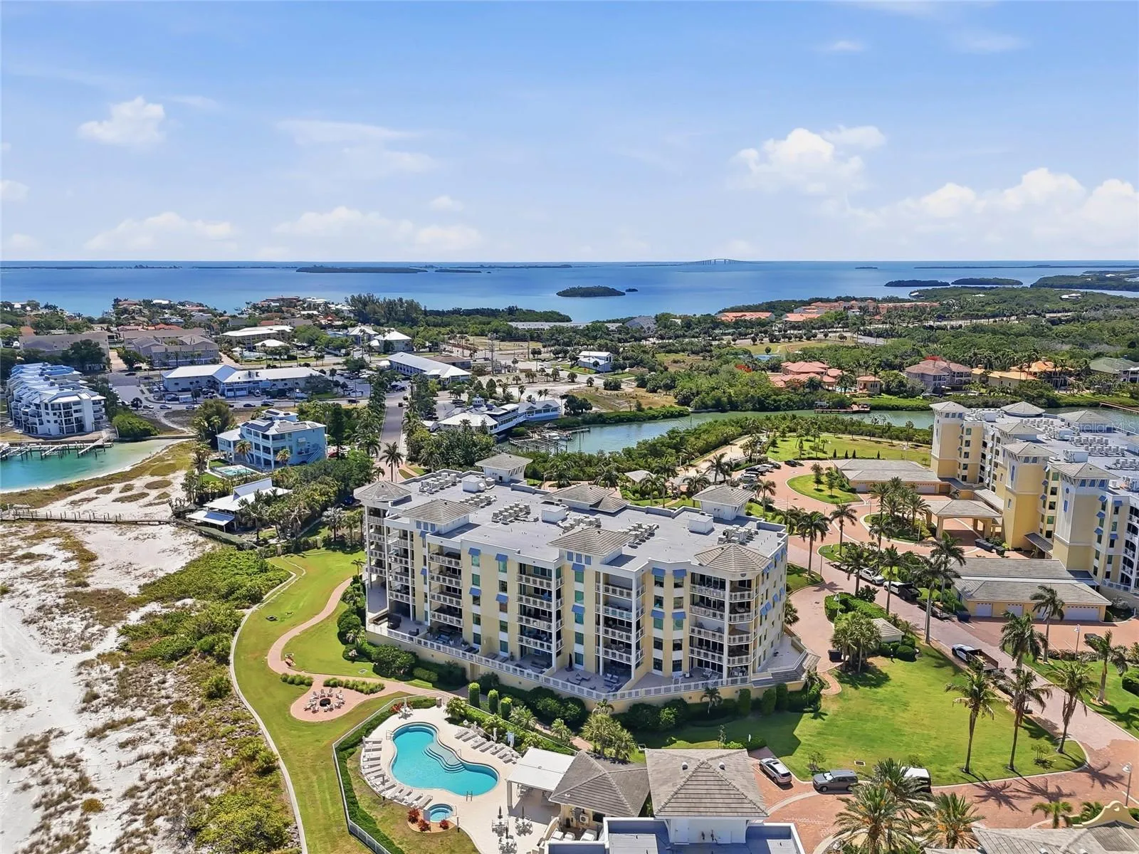 Aerial view highlighting the beachfront location and resort-style pool. Tierra Verde and the beaches close to Fort Desoto is an amazing Paradise!  Live here now!