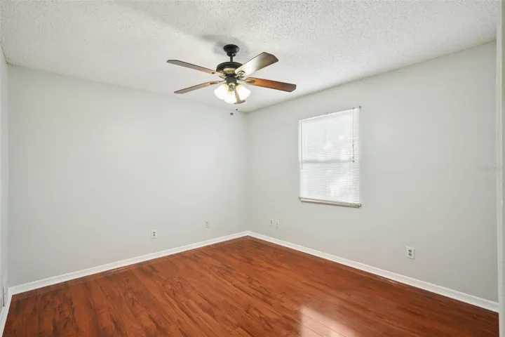 Third bedroom with laminate flooring and wall close