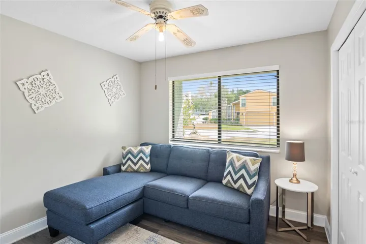 This guest bedroom is being used as a separate room for relaxing or watching a show.