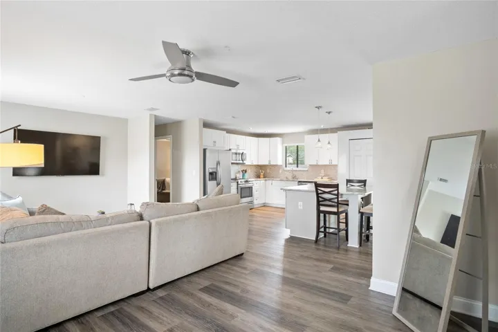 A smooth transition from the living room to the kitchen and then to the dining area.