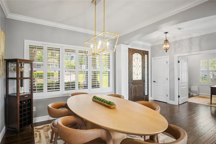 The dining room looking out front through the plantation shutters with the front door and office in the background.