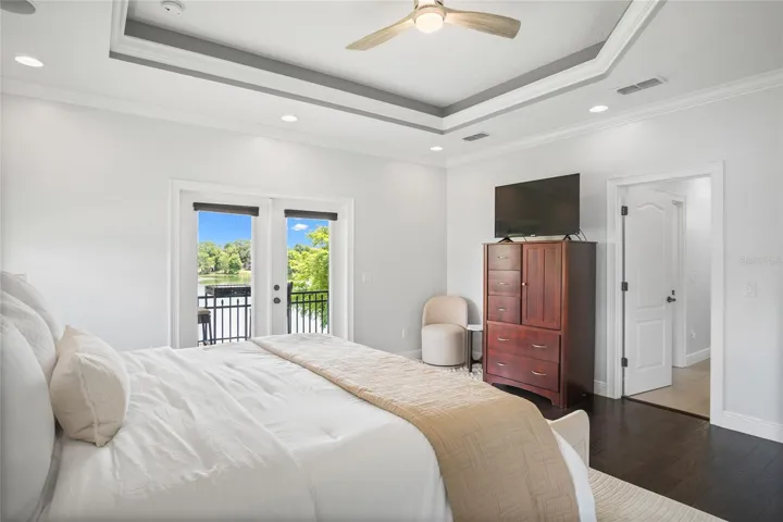 The tray ceiling with recessed lighting shows off the high ceilings emphasizing the space in the room.