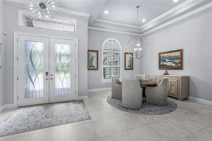 Front Door EntranceTray Ceiling, Light Fixture, Transom Window, and Double Glass Doors