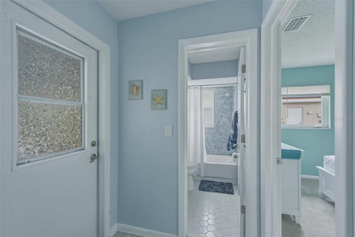 Access to the lanai-pool area and guest bathroom