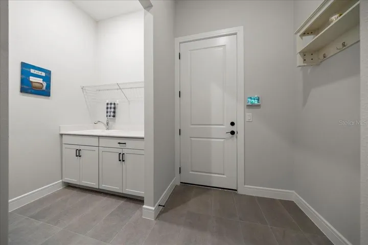 Laundry Room with Cabinets and Sink