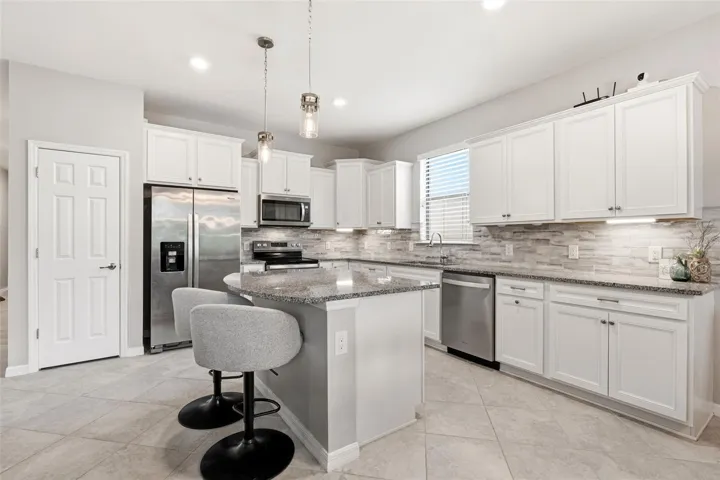 Check out those white wood cabinets and stainless steep appliances