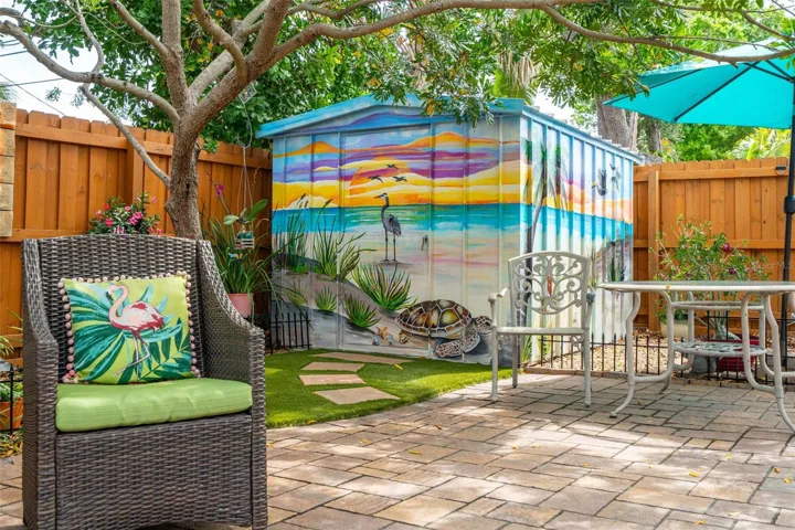 A storage shed keeps pool equipment and gardening tools neatly stored away.