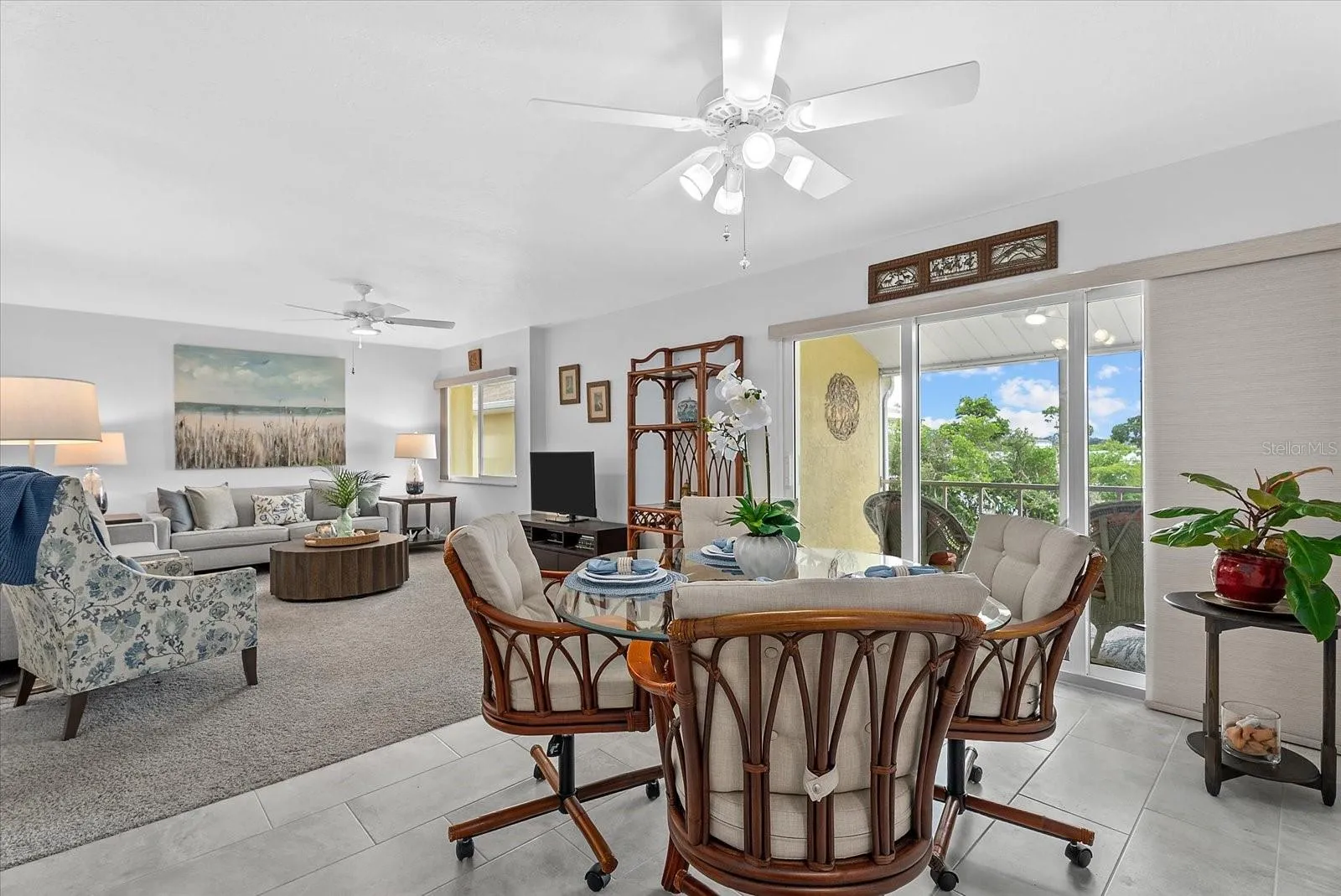Dining room open to the living room and sliders to the screened in balcony