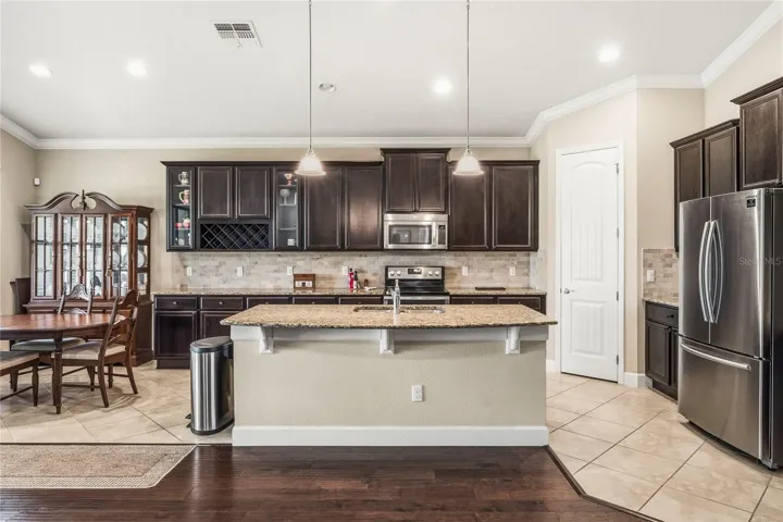 Kitchen with plenty of cabinets, granite counters, crown moldings.