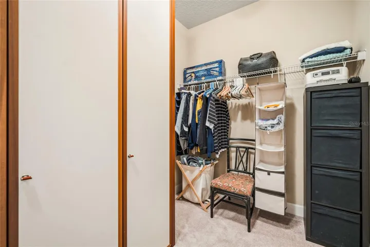 Primary walk-in closet with custom built Italian storage cabinets.