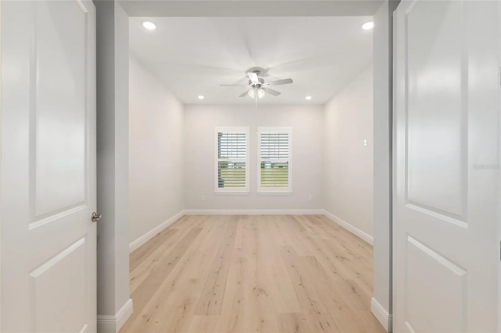Office with french doors adjacent to the living area.