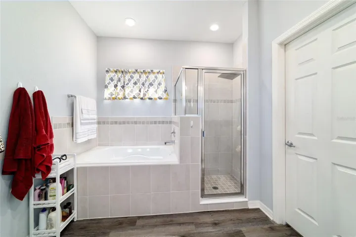 Primary bathroom with garden tub and tiled shower