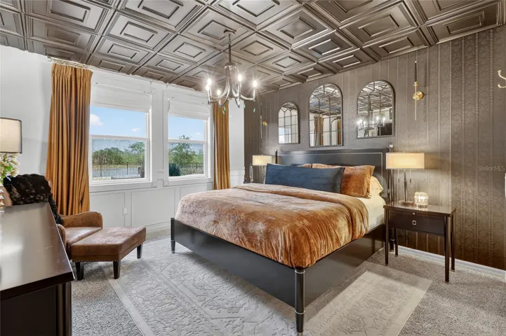 Primary bedroom with coffered ceiling creating an elegant and spacious retreat