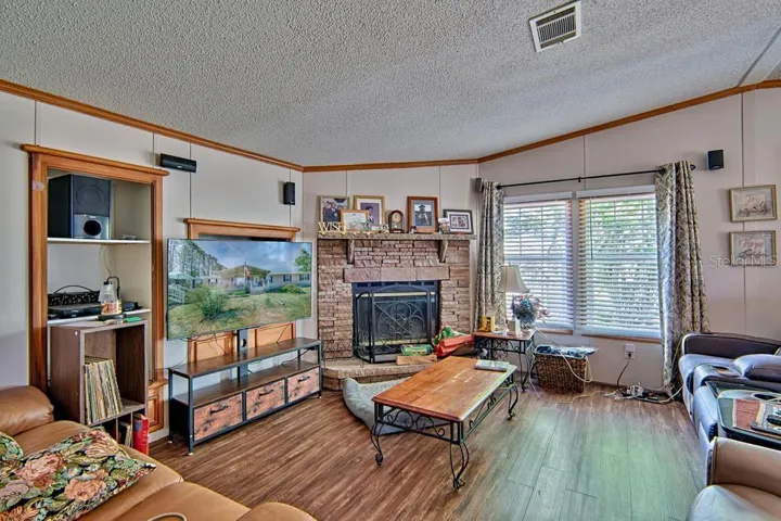 wood-burning fireplace in corner of family room