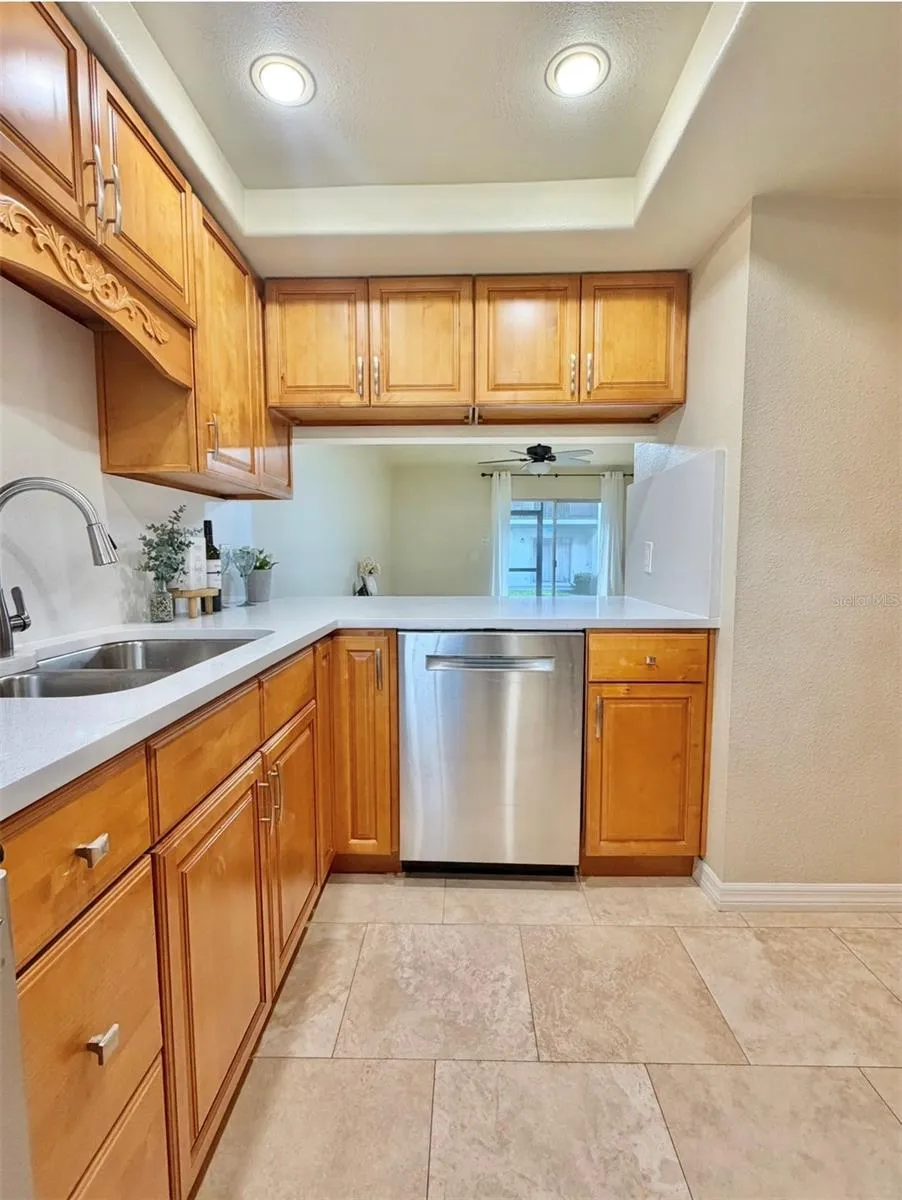 The Kitchen has an opening and bar space to the living room.