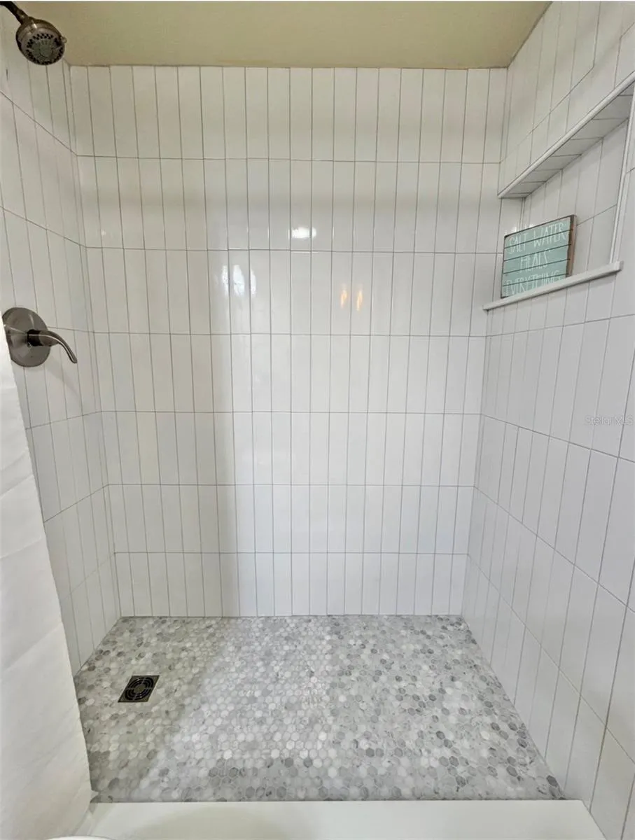 The brand new walk-in shower was professionally built, and it has new fixtures and a niche too!