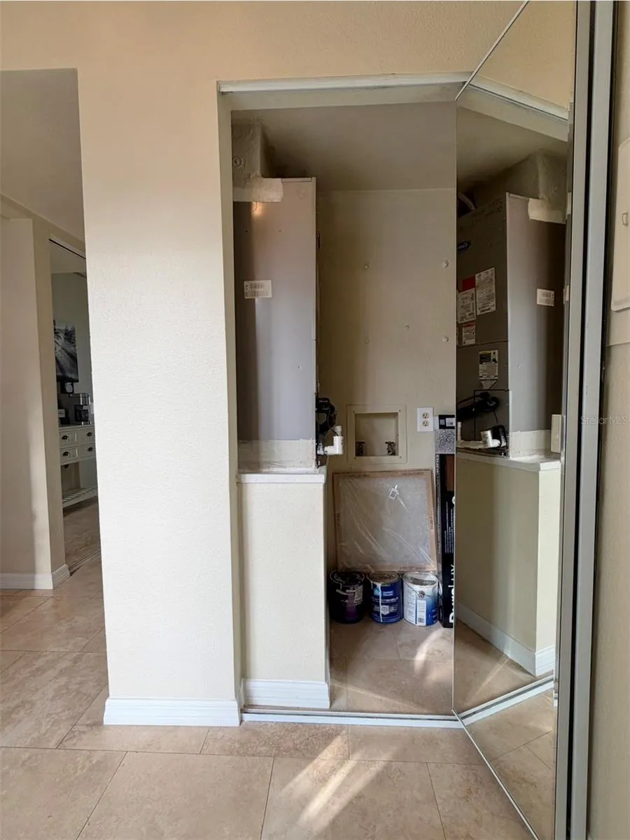 Air handler and BRAND NEW hot water heater closet, has storage space too.