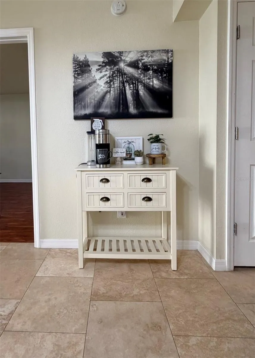 Travertine floors are throughout the living room, the kitchen and hallways.