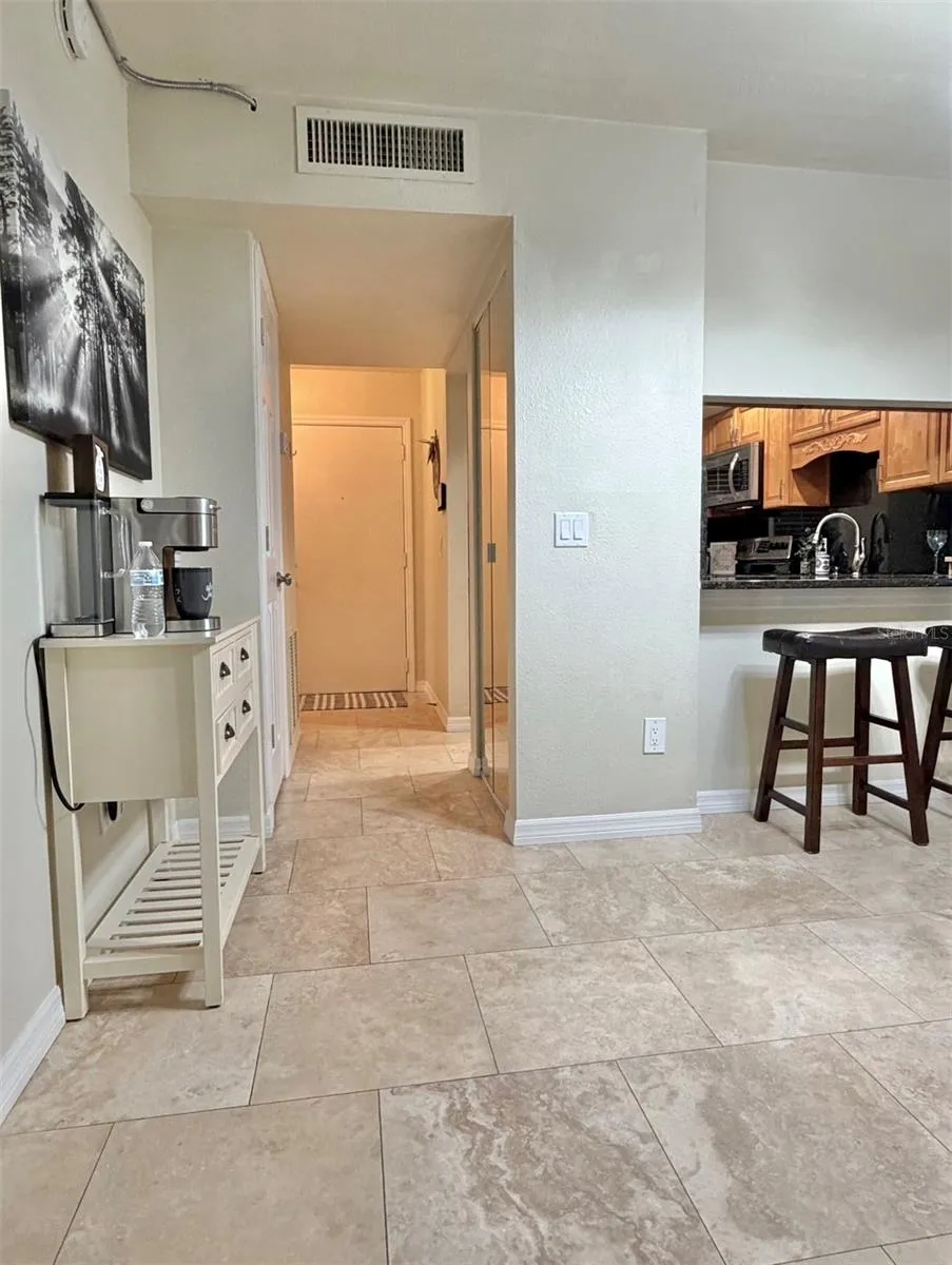 Travertine floors are throughout the living room, the kitchen and hallways.