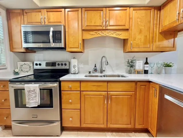 The Kitchen features brand new quartz countertops installed Sept 2026....solid wood cabinets, a brand new sink and faucet, updated lighting, stainless appliances, and travertine floors.