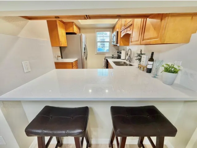 The Kitchen has an opening and bar space to the living room.