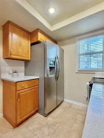 There's extra counter and cabinet space next to the refrigerator.