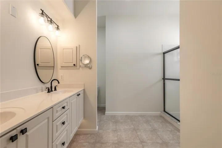 Beautiful primary bathroom with double sinks and step down shower