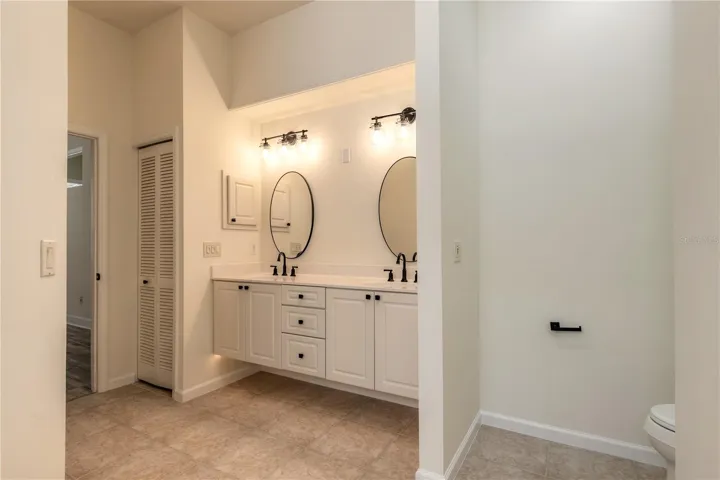 Beautiful primary bathroom with double sinks and step down shower