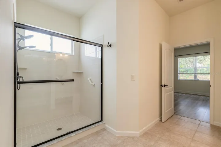Beautiful primary bathroom with double sinks and step down shower