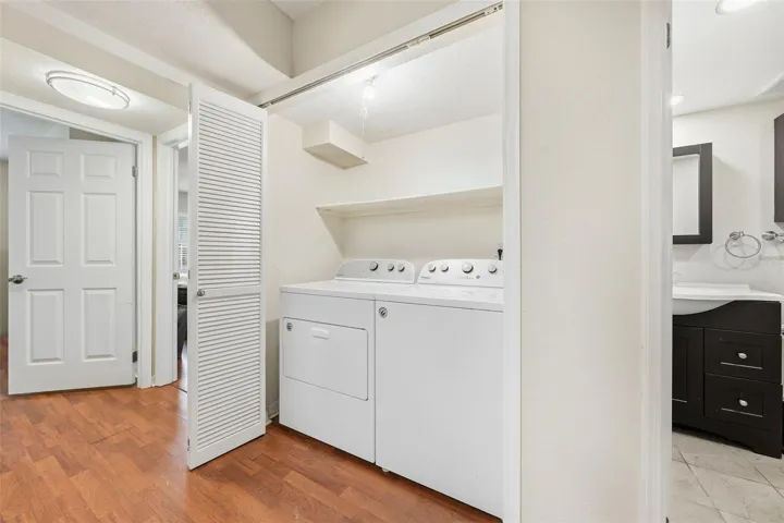 Hallway with laundry closet, washer & dryer stay!