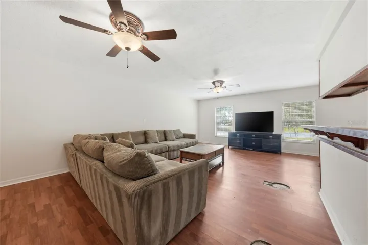 Expansive Living Room. Some flooring needs repair/replace, 3 circular spots (as seen in photos)