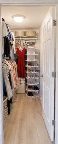Master Bedroom walk-in closet featuring a rotating shoe rack, organized heavy duty shelving, and ample hanging space.